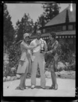 Women and man with trophy, Lake Arrowhead, 1929