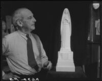 Sculptor Eugene Morahan with a model of his statue of Saint Monica, circa 1934