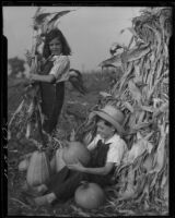 Maxine Cates and Sonny Cates with corn and pumpkins, Santa Monica, 1931