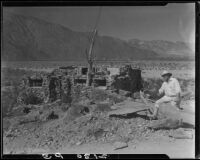 Man in front of a small stone building in the desert, Palm Springs vicinity