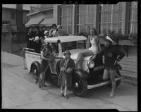 Swimmer Helene Madison with Santa Monica lifeguard, truck, and women at Grand Hotel, Santa Monica, 1933