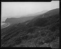 Coastal view from hill towards house under construction in the Rancho Malibu la Costa development, Malibu, circa 1927