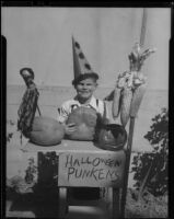 Boy at table with Halloween decorations, Los Angeles, circa 1935
