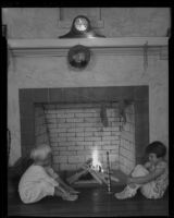 Girls in pajamas at fireplace, Los Angeles, circa 1935