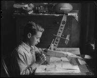 Boy making model airplane, Los Angeles, circa 1935