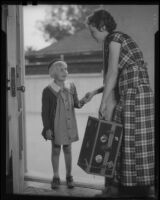 Girl and woman in doorway with trunk, Los Angeles, circa 1935