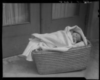 Baby in basket at doorstep, Los Angeles, circa 1935