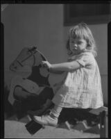 Girl riding wooden horse, Los Angeles, circa 1935