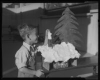 Boy with model house and tree, Los Angeles, circa 1935