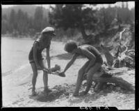 Girls playing in sand on lakeshore, Lake Arrowhead, 1929