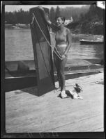 Young woman with aquaplaning board and dog, Lake Arrowhead, 1929
