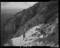 Men, Clarice Barclay, and girl on rocky hillside, near Magic Mountain, Ventura County, 1930