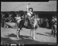 Child rodeo perfomer Little Buck Dale doing rope trick on horse, Lake Arrowhead rodeo, Lake Arrowhead, 1929