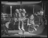 Mawby triplets on merry-go-round, Malibu, 1928