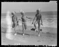 Mawby triplets jumping rope on beach, Malibu, 1928