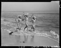 Mawby triplets running in surf, Malibu, 1928
