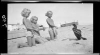 Mawby triplets with a cormorant on the beach, Malibu, 1928