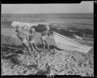 Mawby triplets with a rowboat on the beach, Malibu, 1928