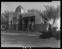 Mrs. Jack Pfister and A. Boyd Mewborn at roadside fruit store, Indio, 1931-1948