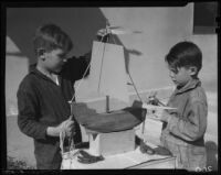 Boys making model sailboat, Los Angeles, circa 1935