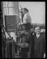 Man and young woman with plaque on mast of S.S. Constitution, San Diego Harbor, San Diego, 1934