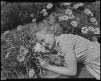 Santa Monica College student lying among flowers, Santa Monica, 1934