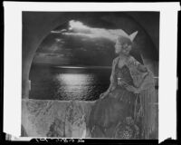 Montage photograph of young woman in arched window at sunset, [1920-1939?]