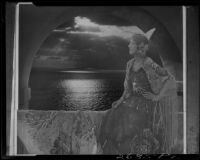 Montage photograph of young woman in arched window at sunset, [1920-1939?]