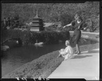Woman and girl on lake shore, Bernheimer Gardens, Pacific Palisades, 1927-1940