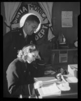 Actress Boots Mallory and an official in a Santa Monica harbor Department office, Santa Monica, 1937