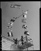 Actress Boots Mallory raising maritime signal flags at the Santa Monica Harbor Department, Santa Monica, 1937