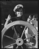 Actress Boots Mallory at a ship's wheel, Santa Monica, 1937