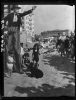 Clown on stilts with children on beach, Santa Monica, 1928