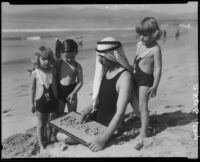 Patsy, Peggy, and Tommy Morgan on the beach with Eugene d'Orange, Santa Monica, 1929
