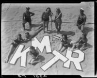Young people on beach promoting radio station KMTR, Santa Monica, circa 1930