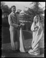 Billy Veditz, in suit and tie, and Carolyn Bartlett, wrapped in war memorial blanket, [Santa Monica], [1931]