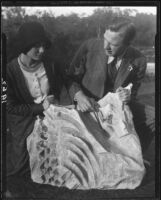 Man and woman with animal fossil, Palos Verdes Estates, 1930 or 1931
