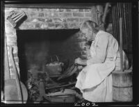 Laura Case Clark at fireplace in log cabin, San Bernardino, 1926 or 1928