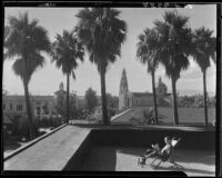 Holton Arms patio, palm trees, St. Vincent Catholic Church, and Automobile Club of Southern California, Los Angeles, [1920-1939?]