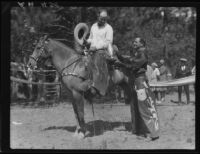 Actor Reginald Denny awarding trophy, Lake Arrowhead Rodeo, Lake Arrowhead, 1929
