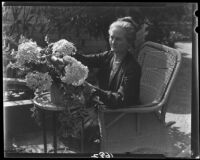 Mary Van Ness Leavitt arranging flowers in her garden, Santa Monica, 1928