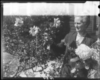 Mary Van Ness Leavitt attending to flowers in her garden, Santa Monica, 1928