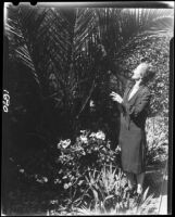 Mary Van Ness Leavitt with palm tree in her garden, Santa Monica, 1928