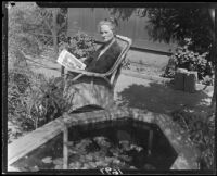 Mary Van Ness Leavitt seated with a magazine in her garden, Santa Monica, 1928