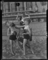 Identical triplet sons of politician George W. Neal playing on the beach, Santa Monica, circa 1930's