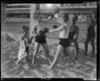 Triplet sons of politician George W. Neal playing on the beach with other children, Santa Monica, circa 1930's
