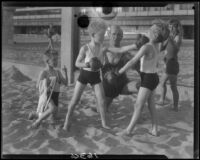 Identical triplet sons of politician George W. Neal playing on the beach with other children, Santa Monica, circa 1930's