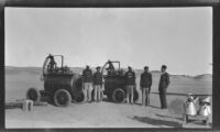 Group portrait of employees of Shell and Imperial Airways next to Shell fuel tanks at a desert runway, Aswān (vicinity) Egypt, 1933