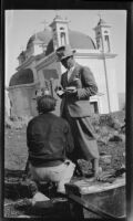 Filmmaker Paul Rotha and cameraman Horace Wheddon in front of the Church of the Seven Apostles during the filming of Contact, Capernaum, 1932