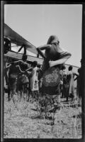 Villagers gathered next to a transport plane after a forced landing, Kigwe, Tanzania, 1932